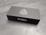Black box with a white Puma TEC logo on the lid; the word 'PUMA' is partially visible on the side.